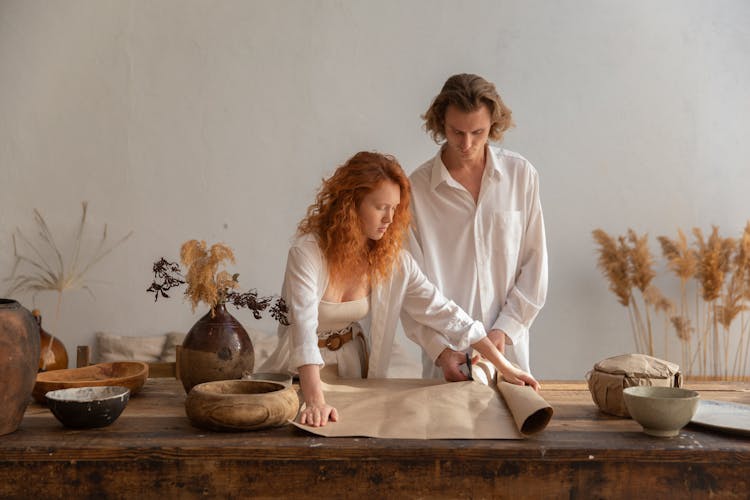 Couple At Table With Craft Paper