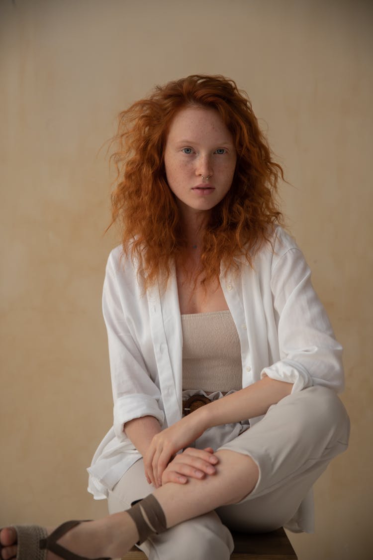 Stylish Redhead Woman Against Wall