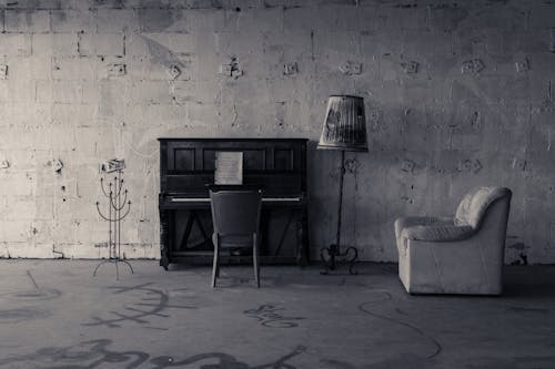 Piano and Armchairs in Abandoned Building