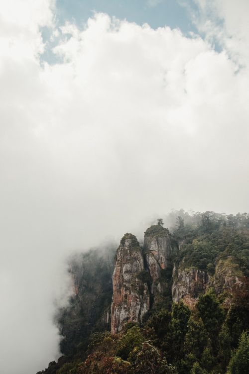 Free Breathtaking misty mountain landscape featuring rocky cliffs and lush forests. Stock Photo