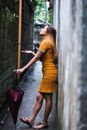 Woman in Yellow Dress Holding Pink Umbrella