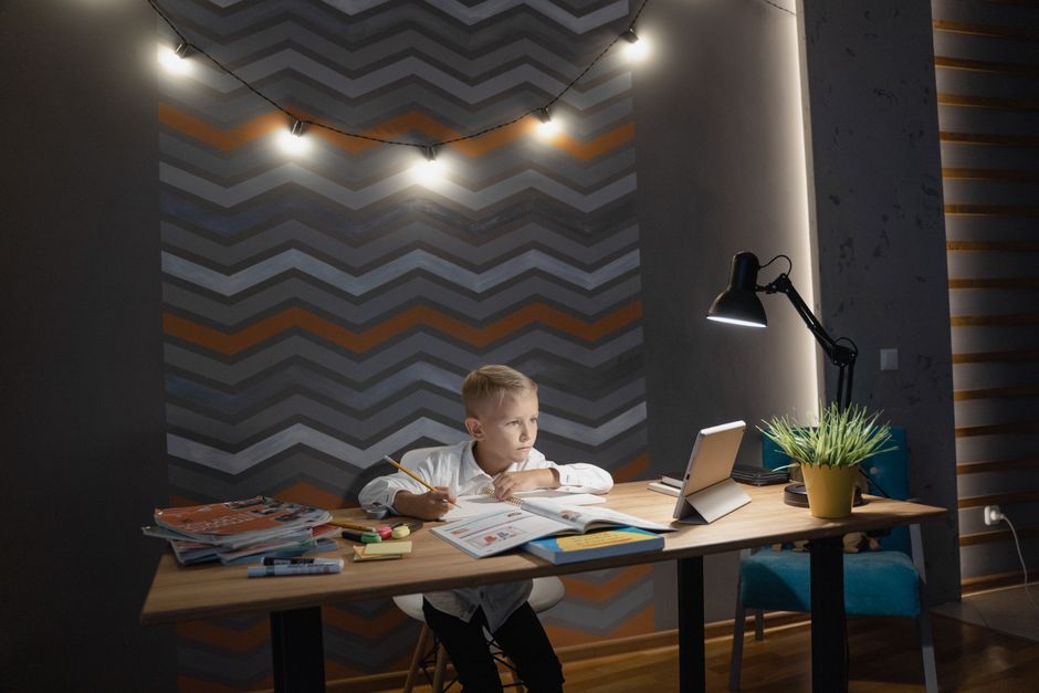 Kompakter Lernplatz im Kinderzimmer mit Schreibtischlampe, Kabelmanagement und Stauraum-Boxen