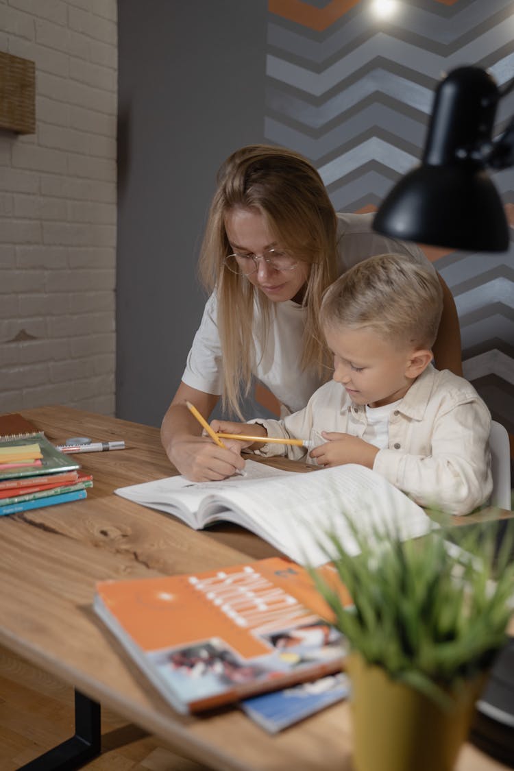 A Woman Teaching A Boy 