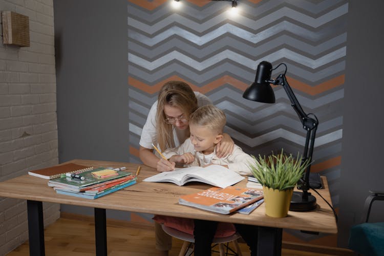 A Woman Teaching A Kid 