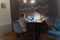 一个小男孩通过笔记本电脑，在现代化的家庭学习环境中参加了一节在线课程