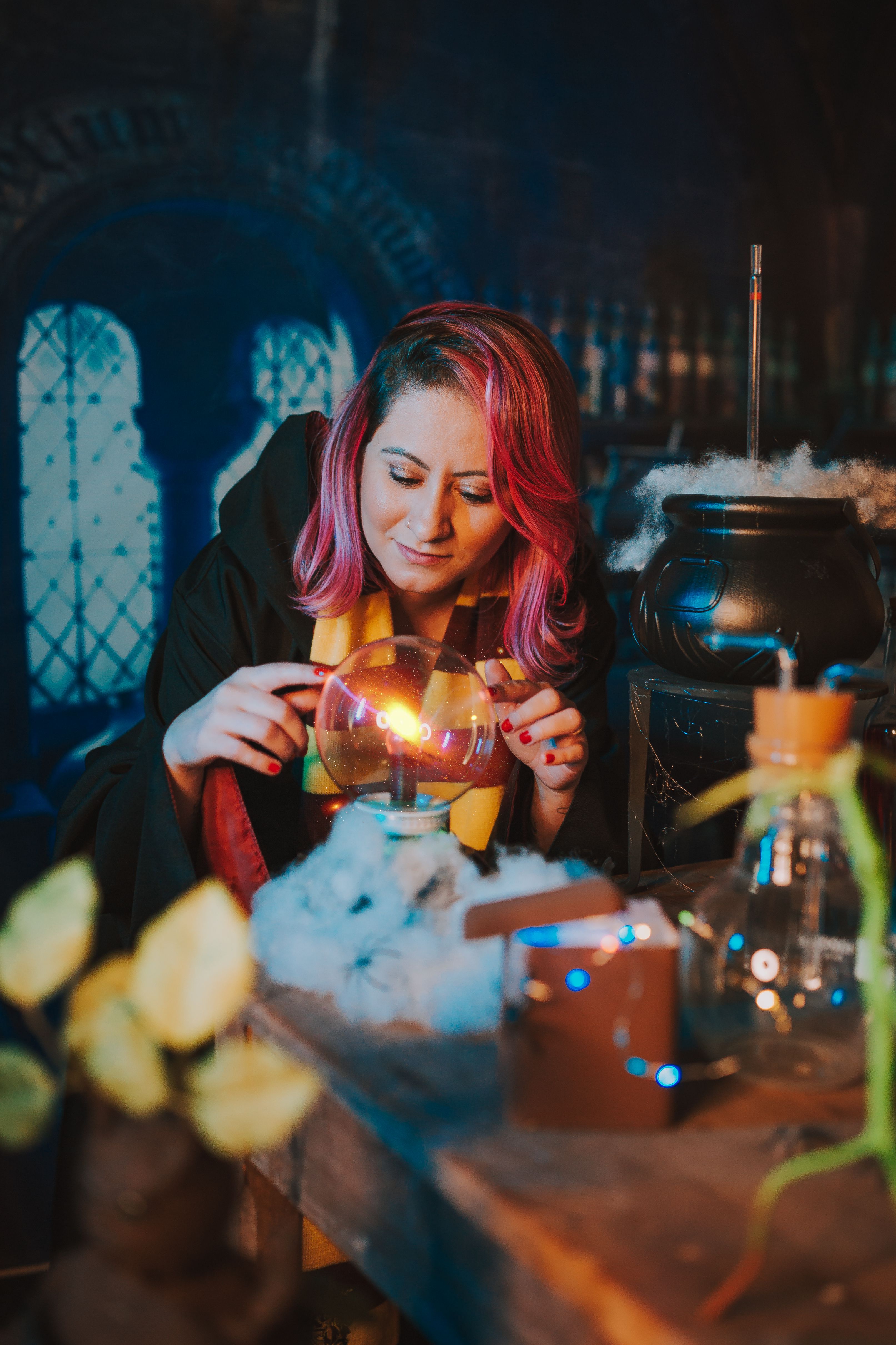 Woman dressed as a fortune teller with a crystal ball in a magical, mysterious setting.