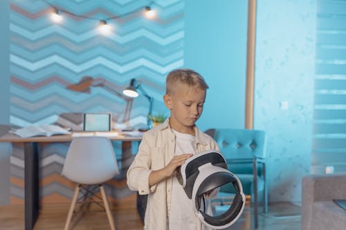 A Kid Holding a VR Headset 