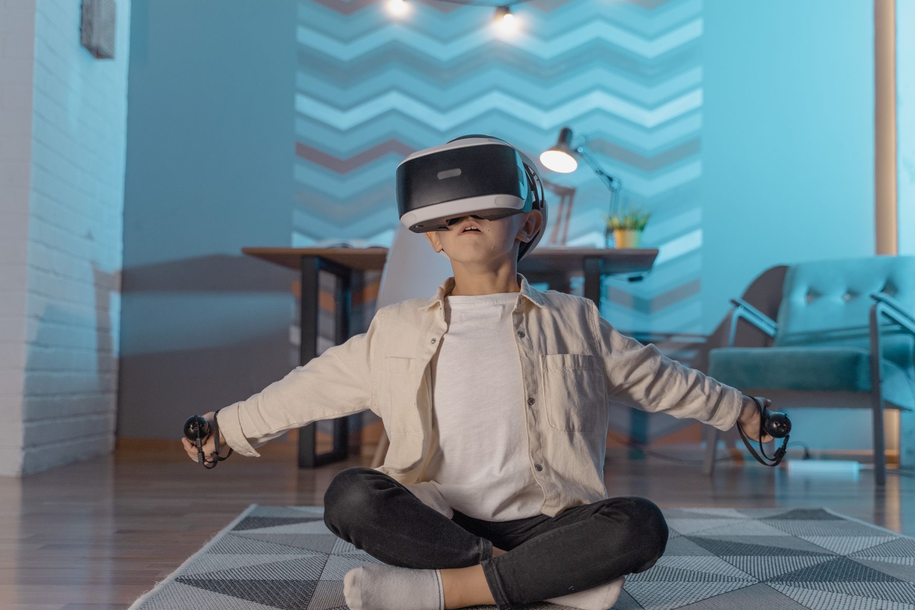 A young boy experiences virtual reality gaming indoors using VR goggles.