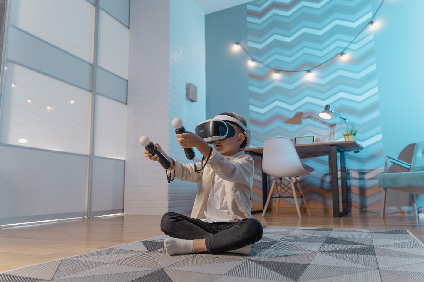Child using a VR headset and controllers at home