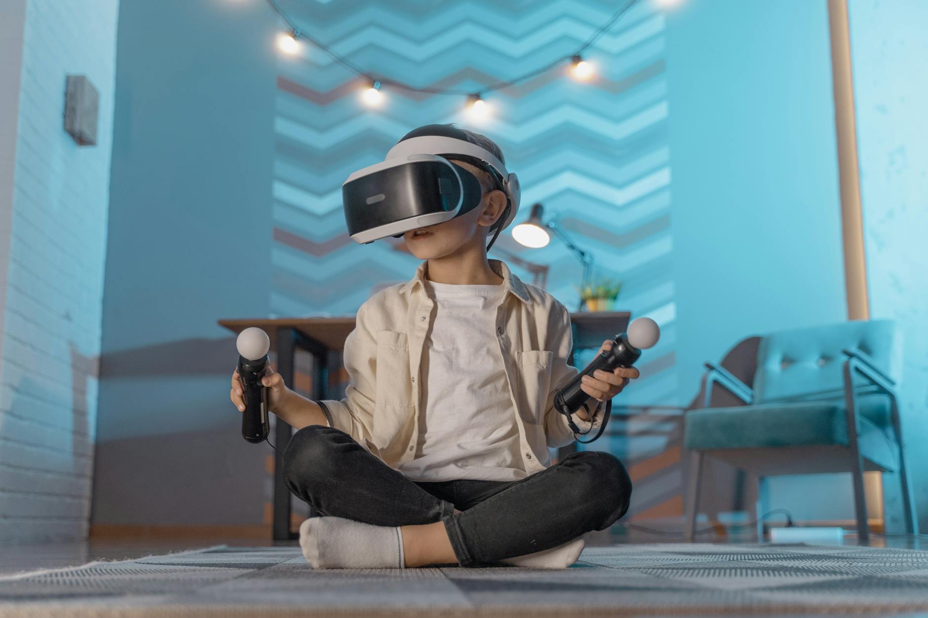 Young boy sitting and playing with VR goggles in a cozy room setting.