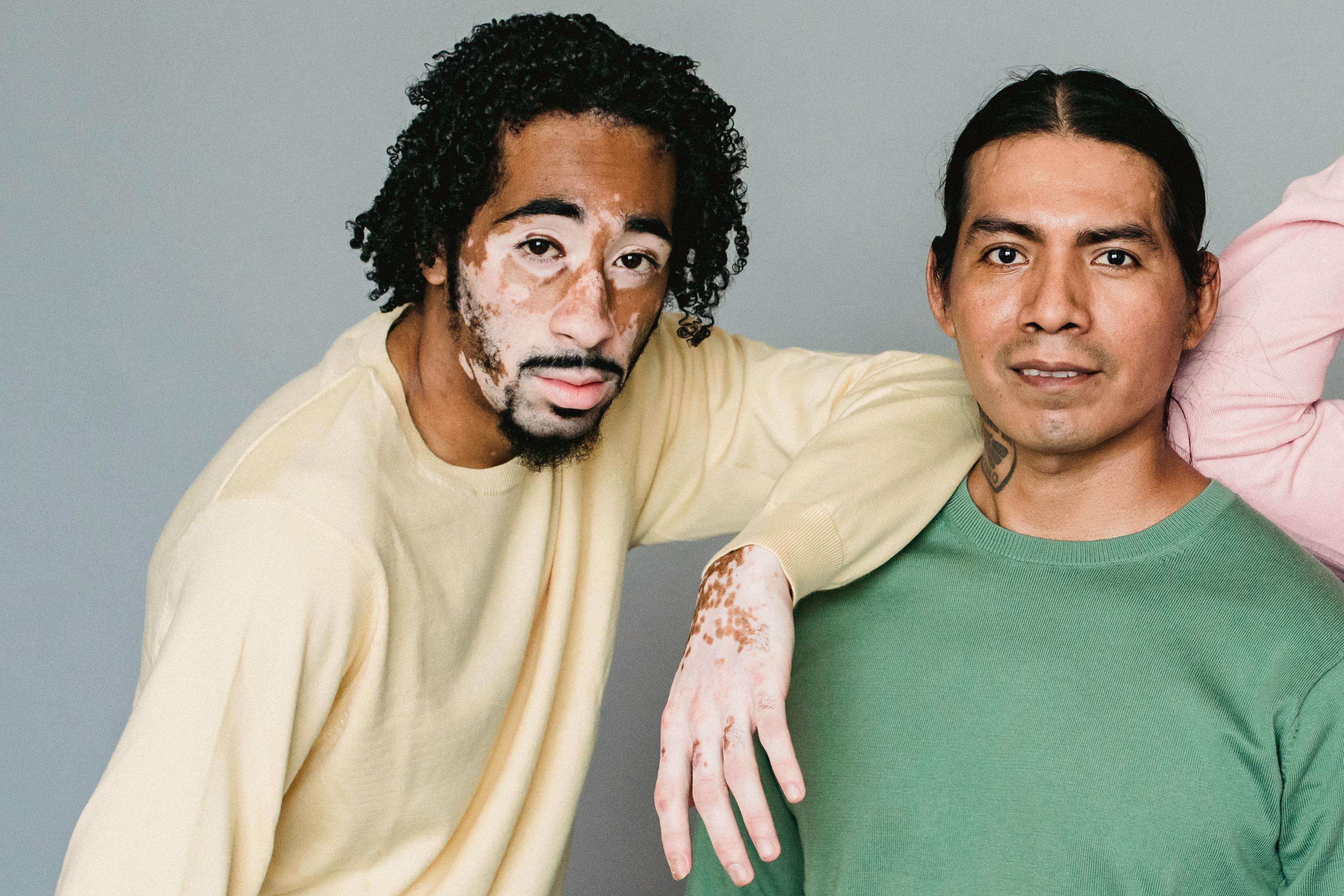 Multiethnic men standing against gray background