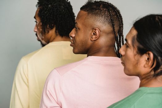 Multiethnic crop men standing in studio