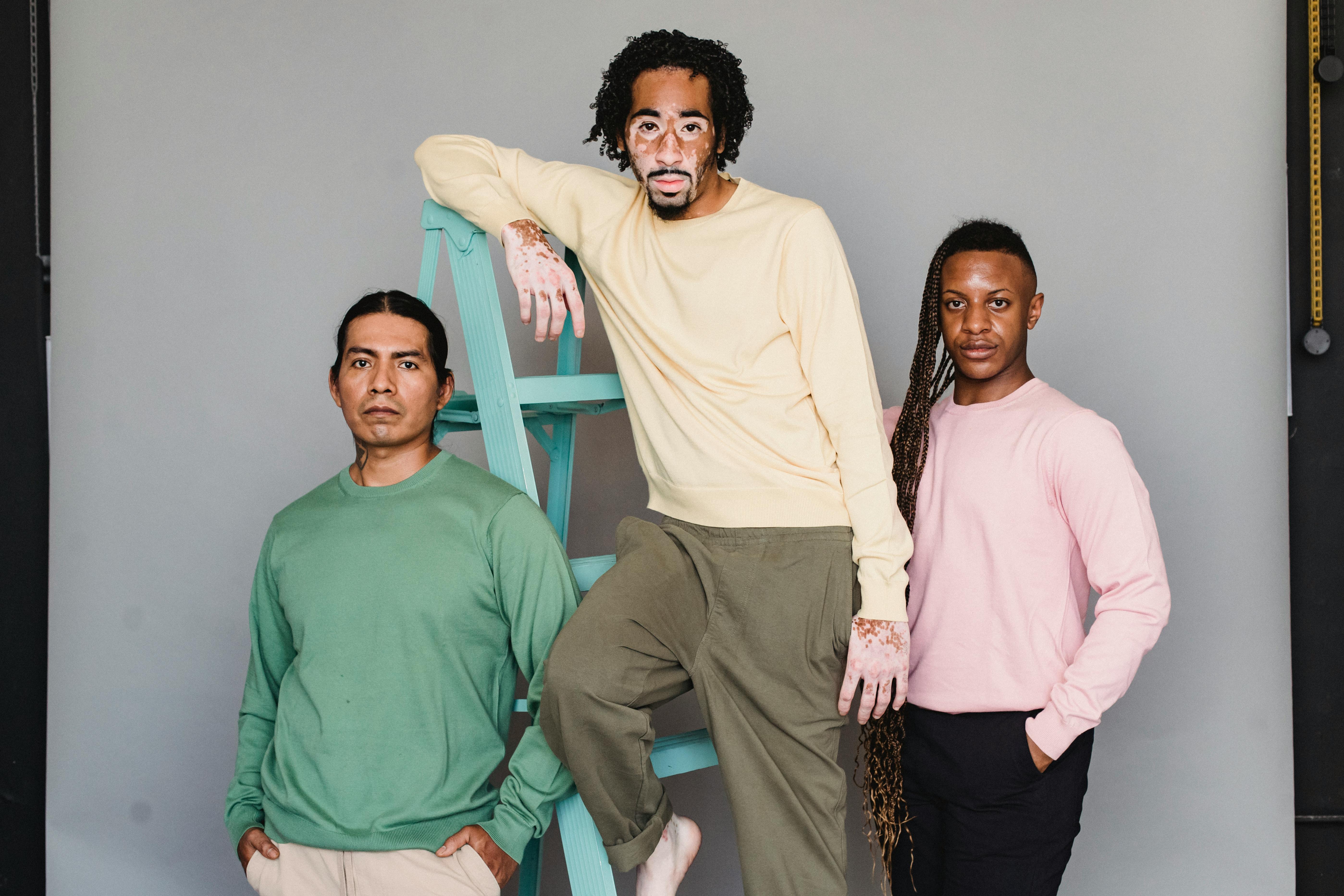 multiethnic men near ladder in studio