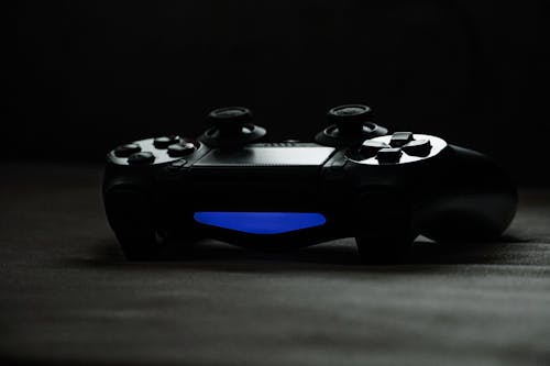 Free Black Gaming Controller on a Black Surface Stock Photo