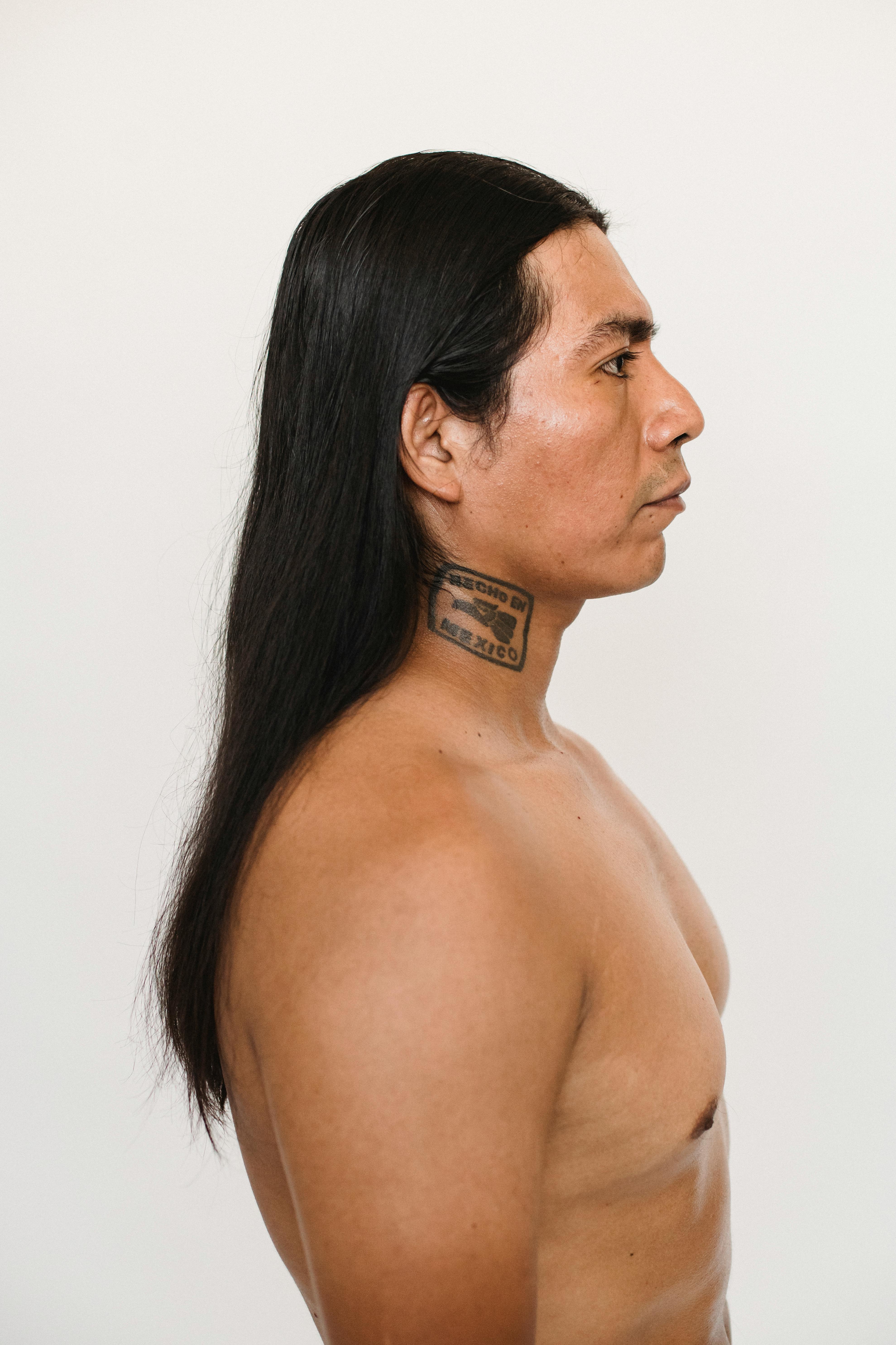 shirtless man with long black hair