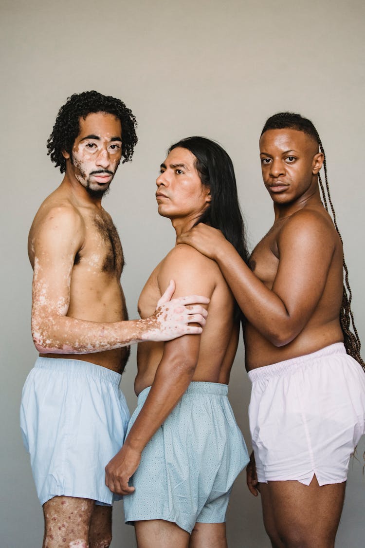 Multiethnic Men In Underwear On Light Background