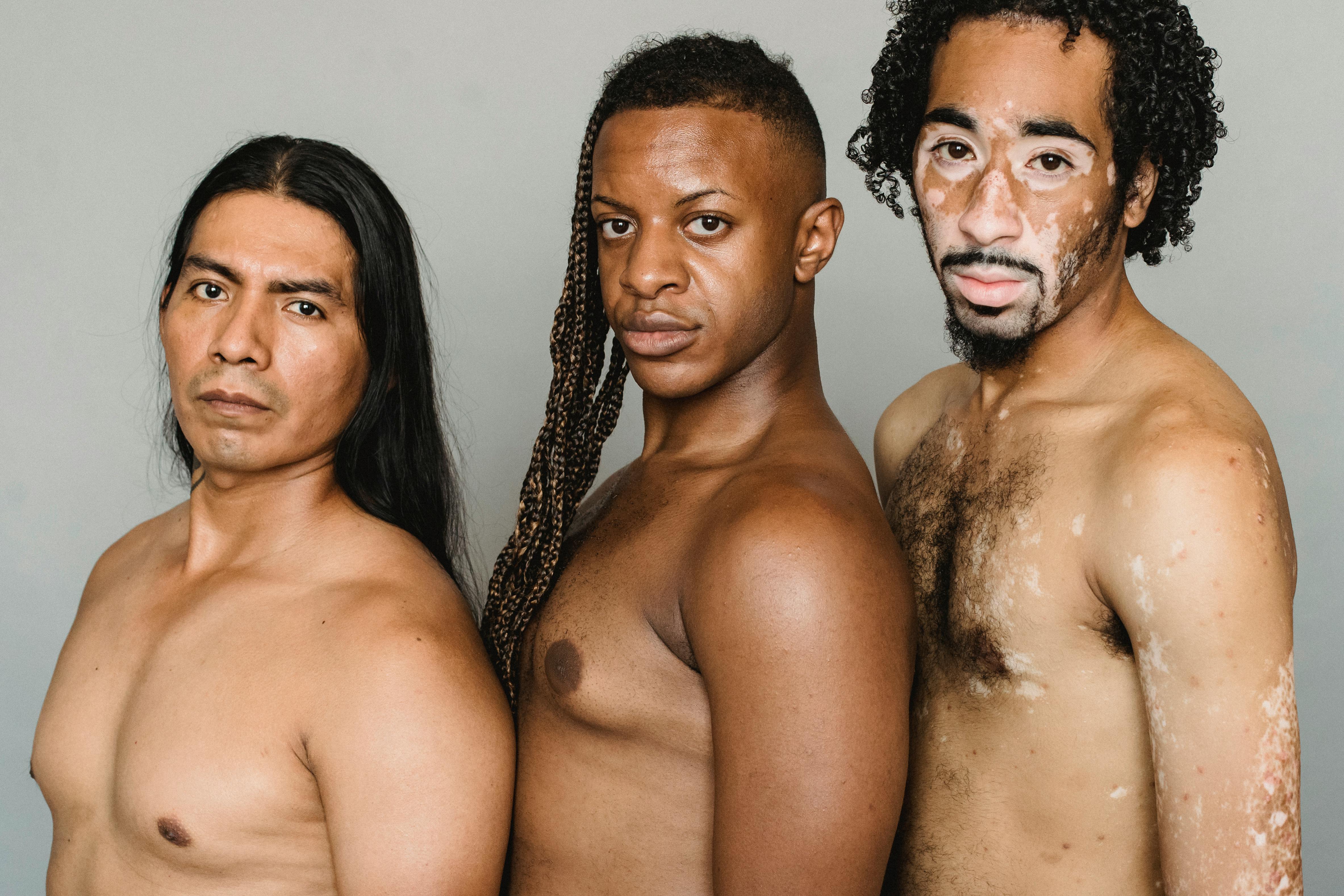 crop shirtless diverse men on light background