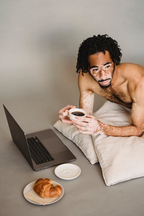 Topless Man Holding White Ceramic Mug