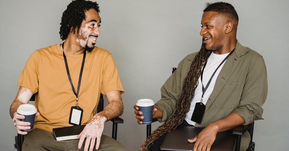 Friends Having A Heated Discussion, One Person Looking Defensive While The Other Appears Accusatory, With A Backdrop Of A Coffee Shop Or Casual Setting