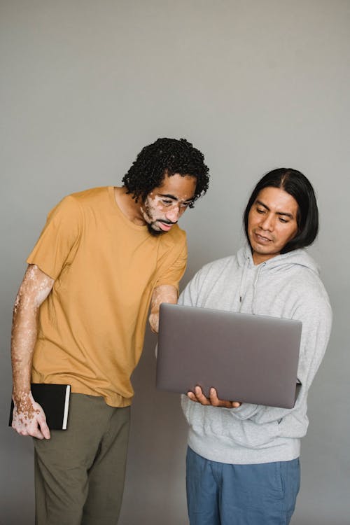 Positive multiracial colleagues using laptop together