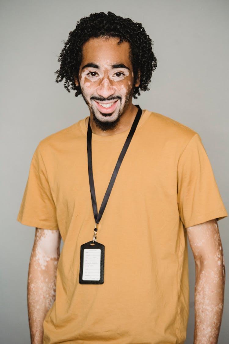 Cheerful Black Man In Badge Holder