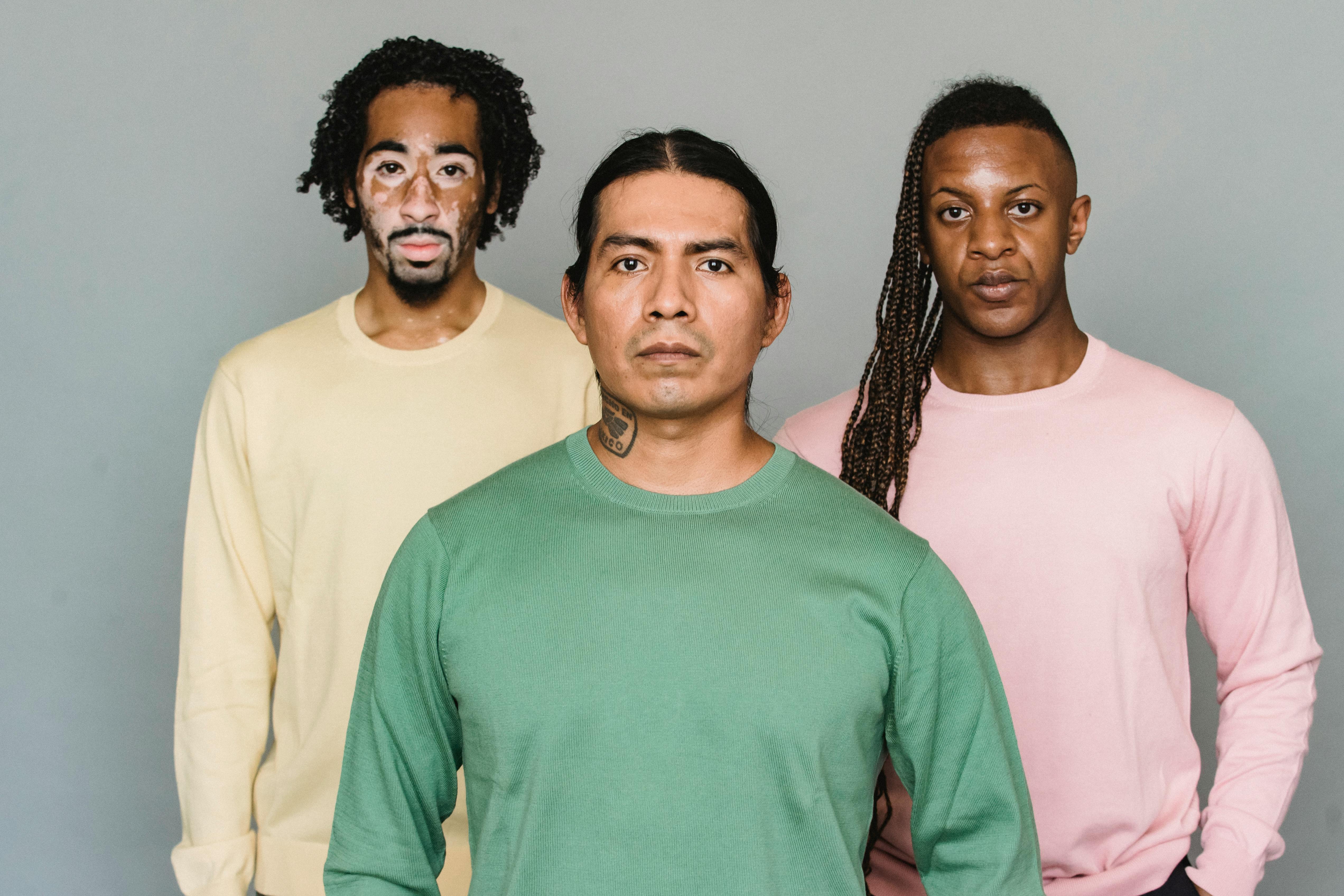 serious multiethnic men standing in studio