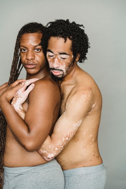 Portrait of a diverse couple showing affection and self-acceptance.