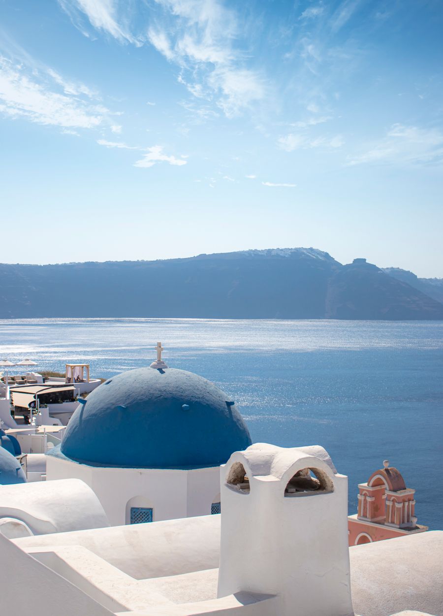 Santorini’s blue domes and white buildings above the Aegean Sea