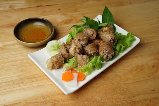 Close-up shot of crispy Vietnamese spring rolls served with fresh vegetables and dipping sauce.