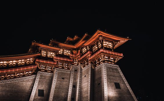 Illuminated Chinese temple at night showcasing traditional architecture.