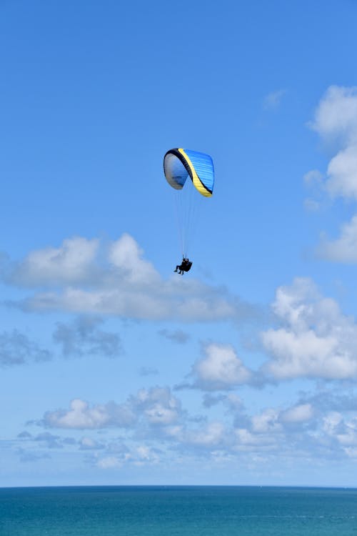 Person in Parachute Under Blue Sky