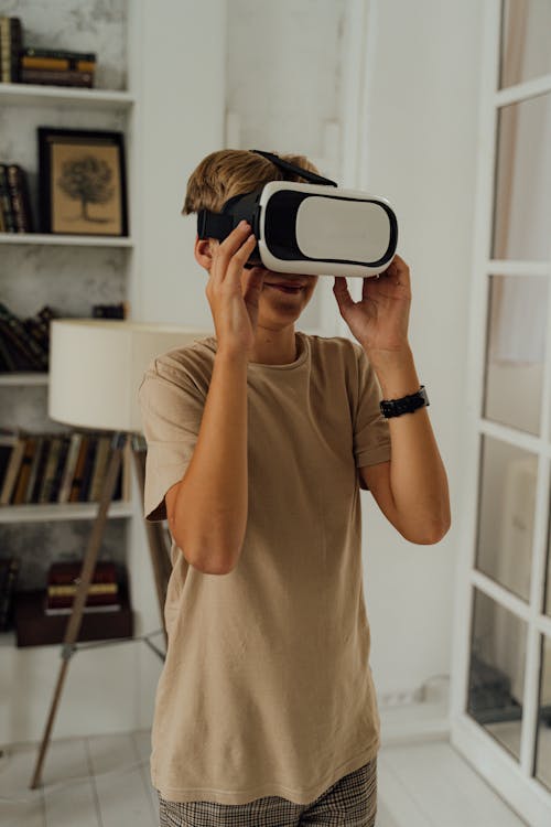 Boy in Brown Shirt Playing a Virtual Reality Video Game