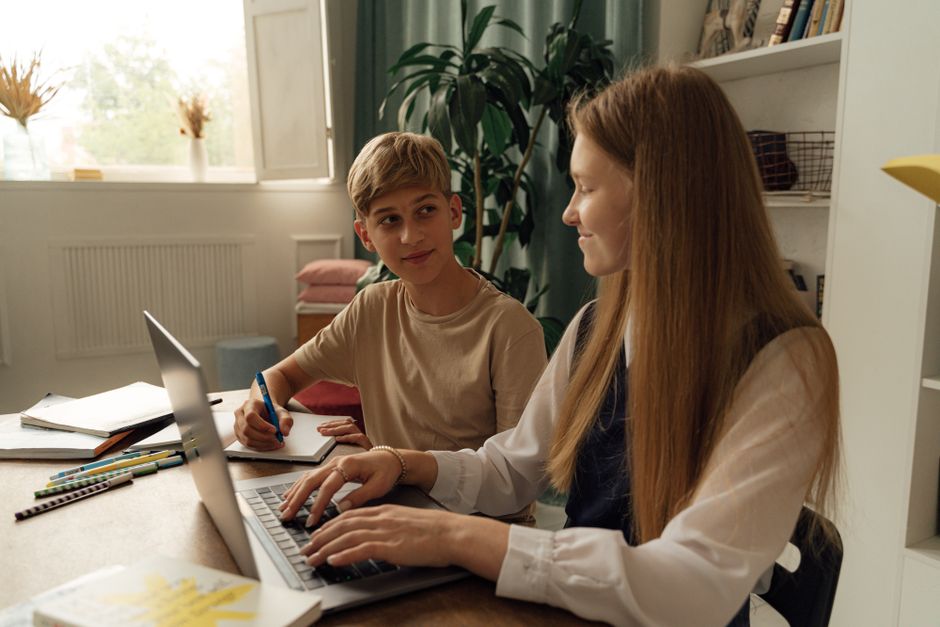 Students learning together around a laptop