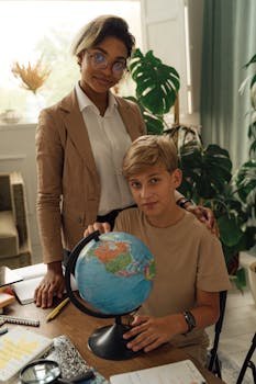 A teacher and a student exploring geography with a globe in a classroom environment.