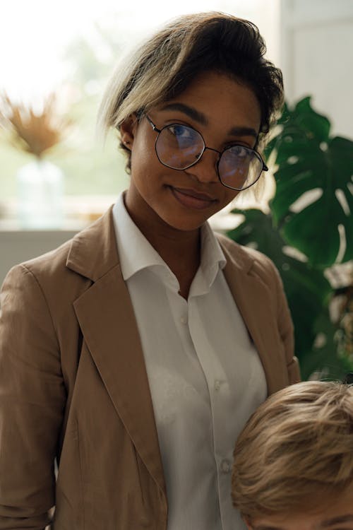 Woman in Brown Blazer Wearing Black Framed Eyeglasses