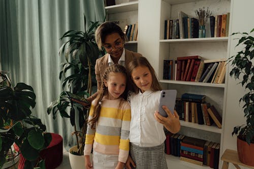 Free A Teacher and Students Taking a Selfie Together Stock Photo