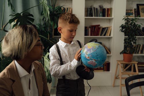 A Boy Holding a Globe