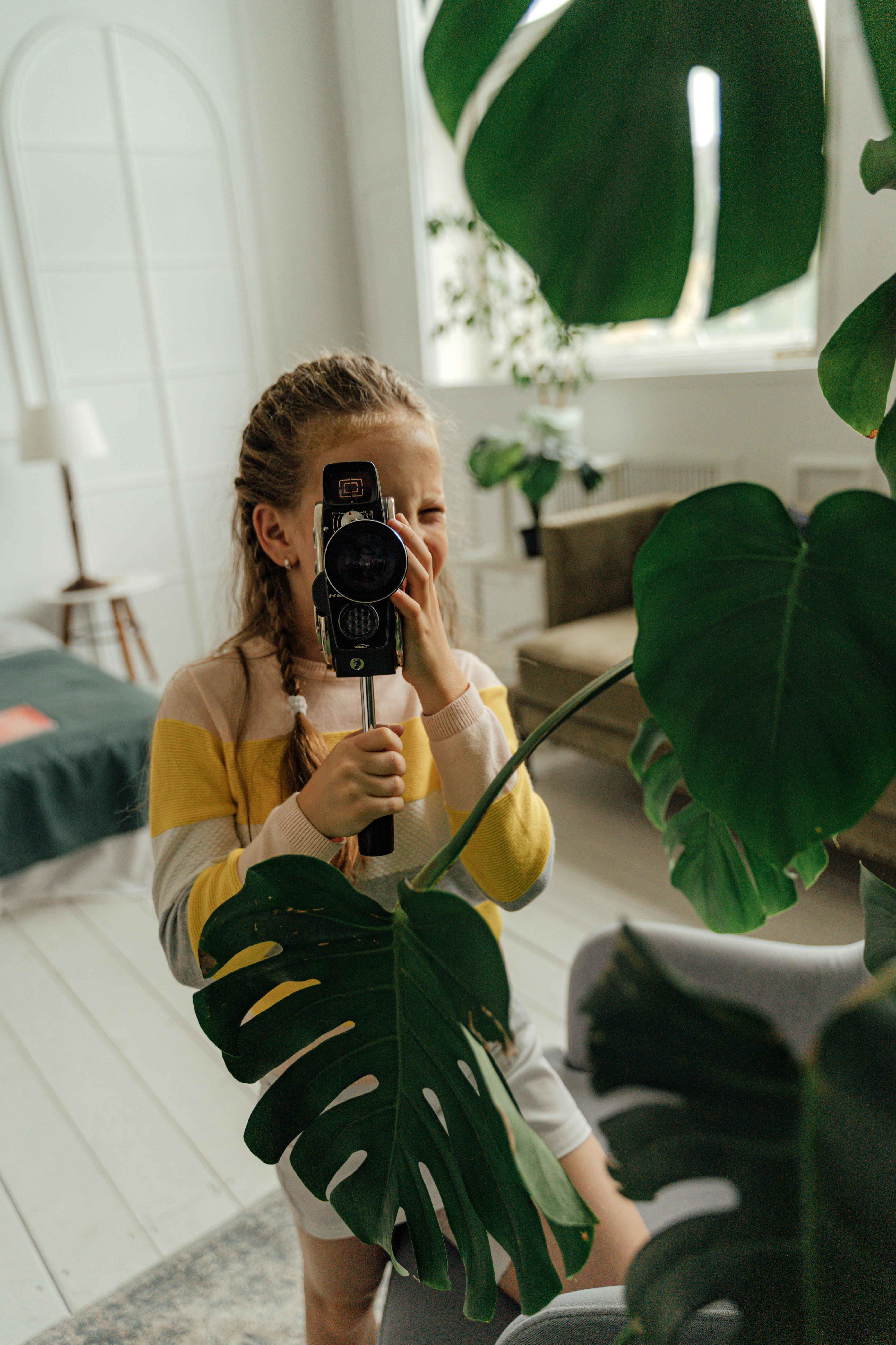 little girl holding a camera