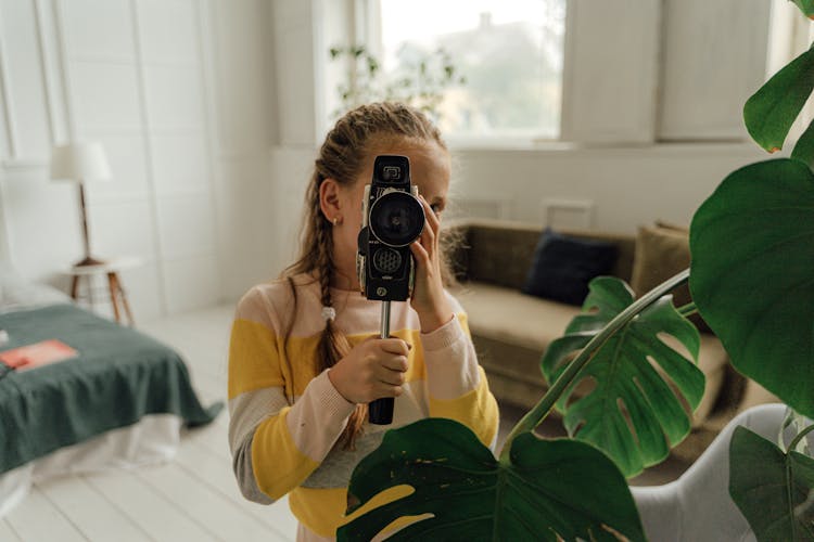 Girl Using Old Style Movie Camera