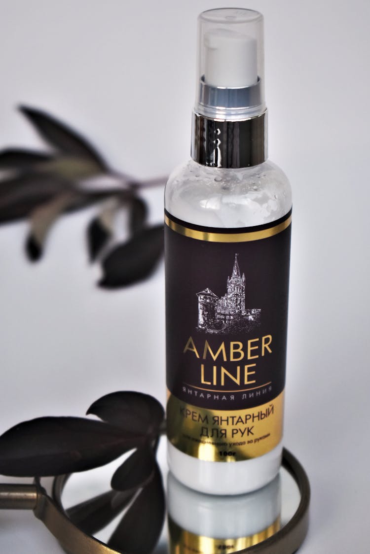 Studio Shot Of Cosmetic Bottle With Black And Gold Label