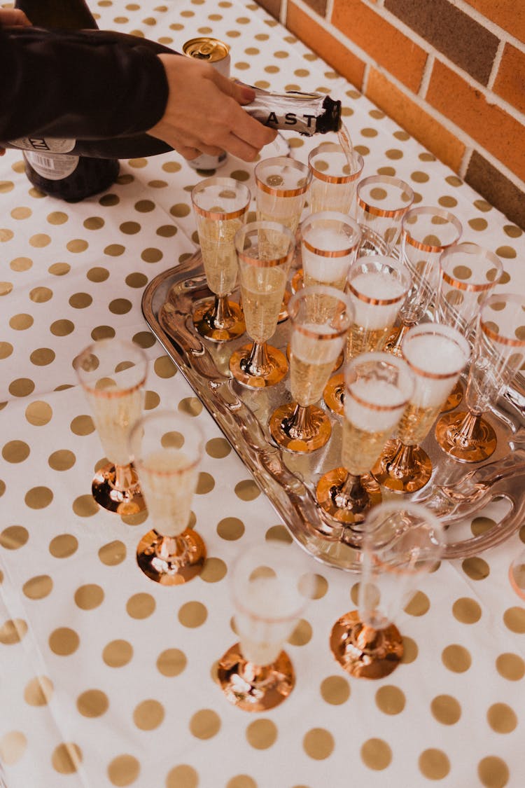 Crop Person Serving Refreshing Aperitif On Table