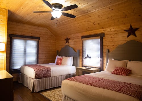 Two Double Beds Inside a Wooden Room