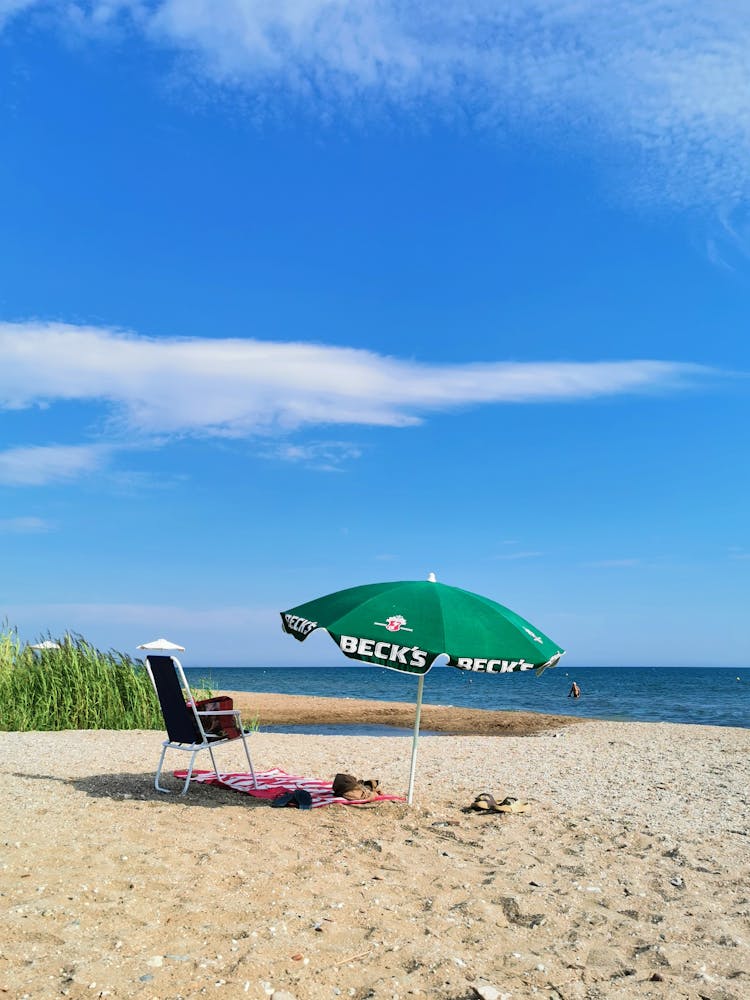 Chair And Beach Umbrella On Seashore