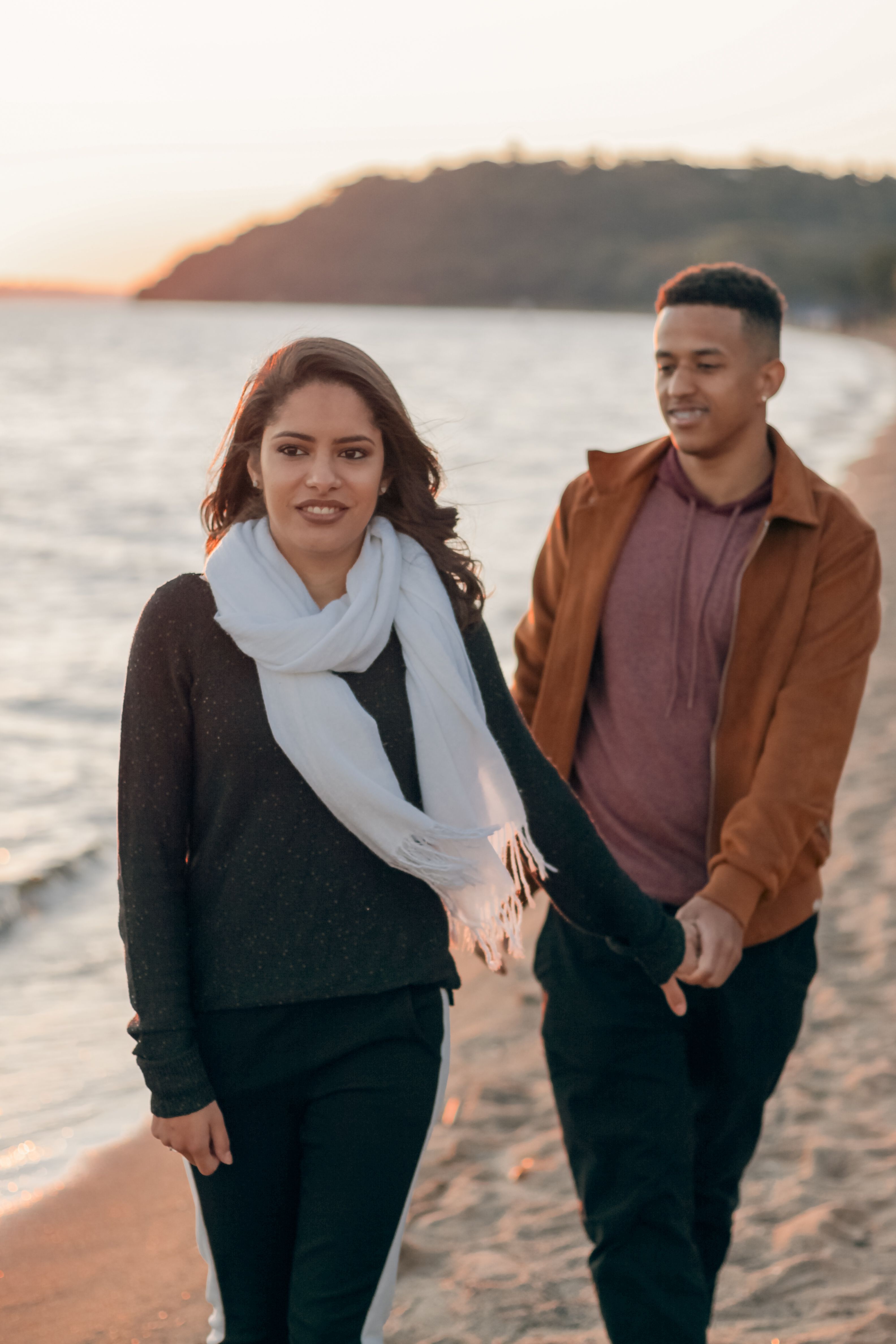 Man in Brown Jacket Holding Hand of Woman in White Scarf · Free Stock Photo