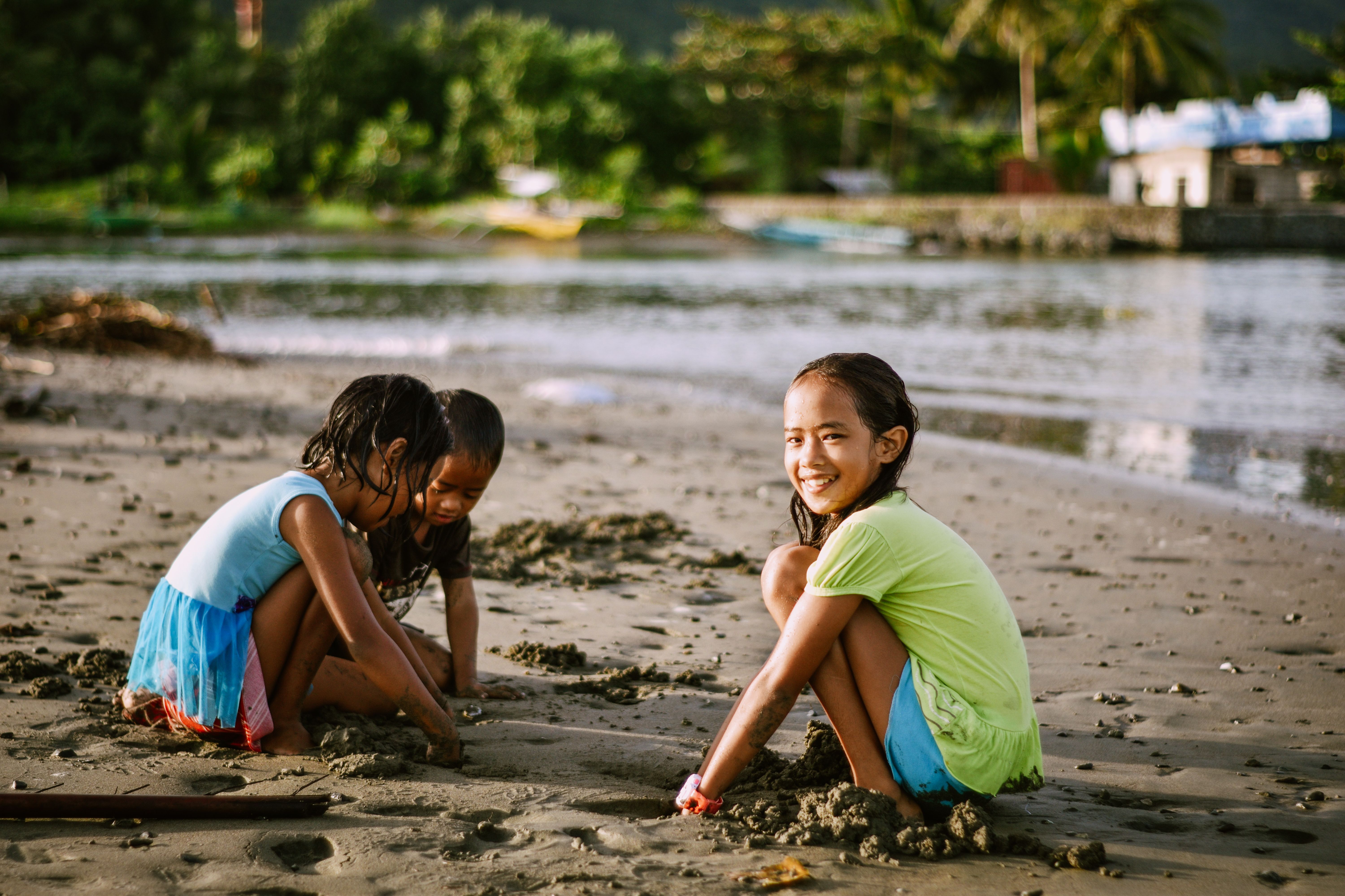 Kids with Wet Hair Playing with Sand on the Beach · Free Stock Photo