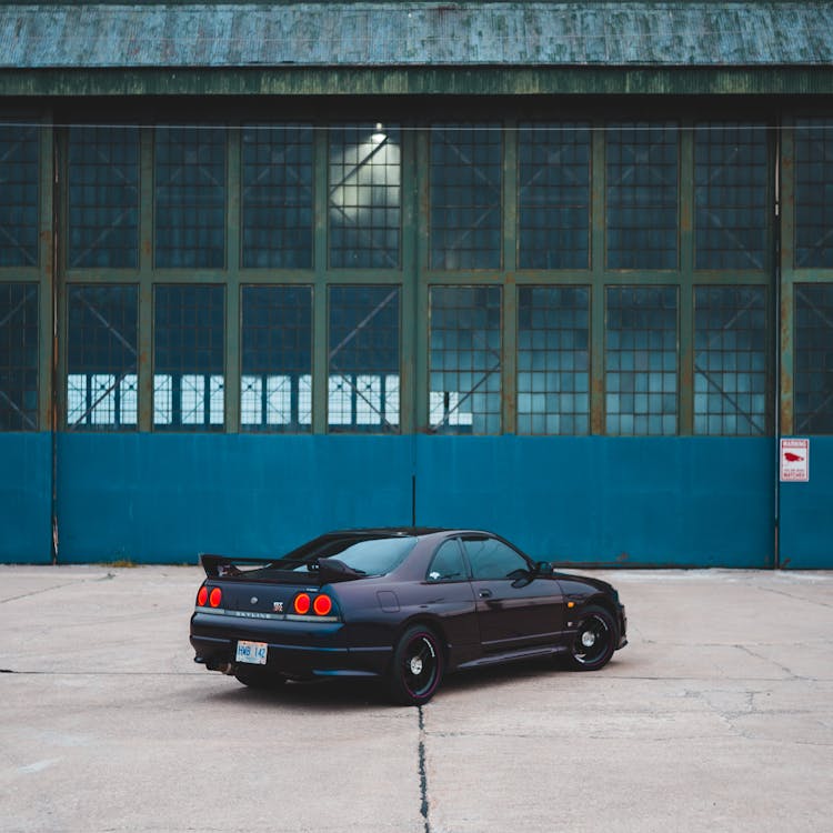 Sports Car On Pavement Near Urban Building