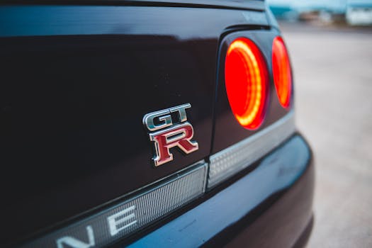 Closeup of sports car bumper with shiny colorful taillights parked on road in daylight