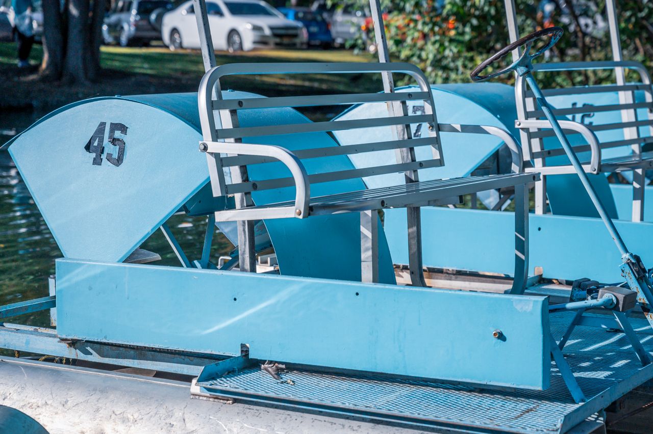 blue metal water bicycles with painted numbers on rippling water in ci