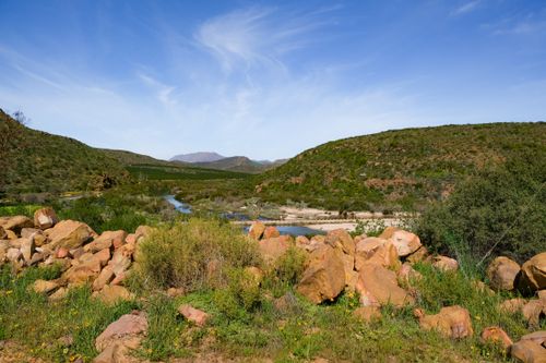 Free Vibrant landscape of river, hills, and rocks under a clear blue sky in Clanwilliam, South Africa. Stock Photo