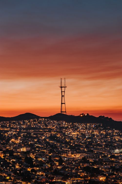 Free Aerial view of modern illuminated city in evening under bright colorful sundown sky Stock Photo